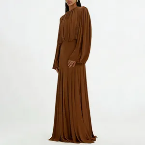 Detail view of an elegant pleated maxi dress in chocolate brown with a cinched waist
