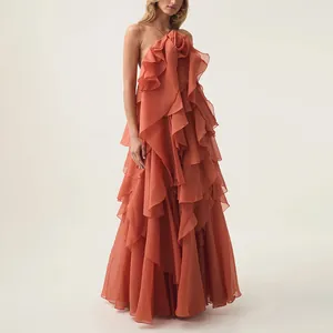 Elegant coral orange tiered ruffled maxi dress with halter neck and backless design