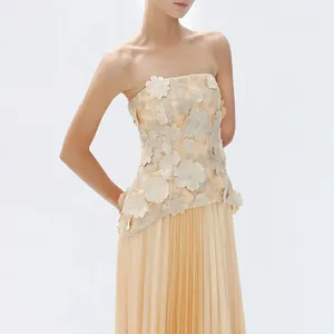 Elegant champagne two-piece set with 3D floral strapless top and pleated maxi skirt.