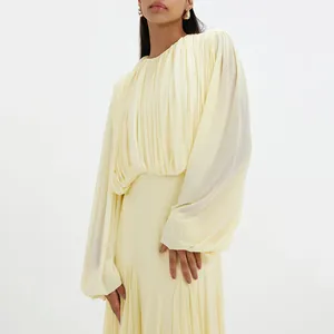 Elegant pale yellow maxi dress with pleated bodice and balloon sleeves detail view