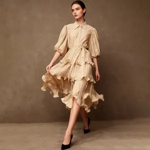 Full shot of elegant beige French style tiered dress with collared puff sleeves