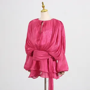 Vibrant pink pleated mesh mini dress with puff sleeves and ruffled hem on mannequin.