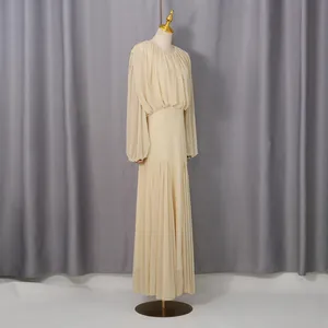 Side view of elegant beige pleated maxi dress with long sleeves and cinched waist