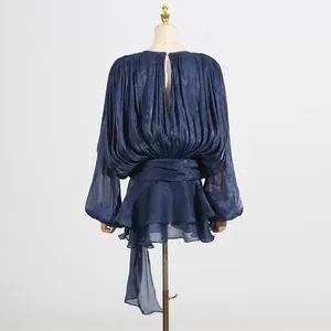 Back detail view of a pleated navy blue mesh mini dress featuring stylish bubble sleeves