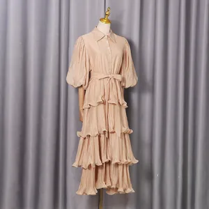 Elegant beige tiered midi dress featuring puff sleeves and a collared button-down front detail.