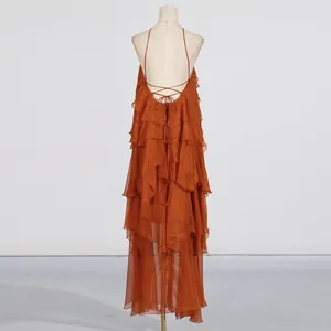 Detail view of elegant burnt orange tiered maxi dress with backless halter design