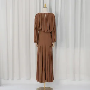 Detail view showing the back of an elegant French style brown long dress with pleats