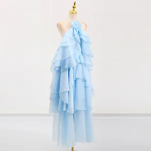 Elegant light blue tiered ruffled maxi dress with halter neck and backless design