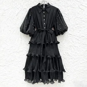 Elegant black French style tiered pleated dress with puff sleeves and rhinestone accents