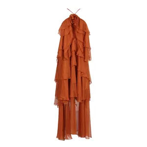 Detailed view of burnt orange tiered ruffle maxi dress with halter neck and open back