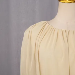 Close-up view of the gathered round neckline on a French style elegant cream dress