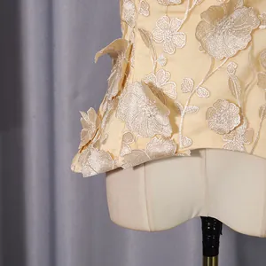 Close-up detail of luxury sleeveless top featuring 3D floral embroidery appliques