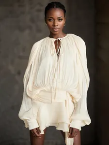 Elegant cream pleated mini dress featuring puff sleeves and ruffled hem design for summer