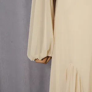 Detail shot of elegant French style cream mesh lantern sleeves on a long dress