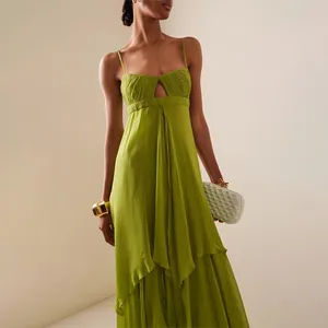 Detailed view of a green pleated bust maxi dress with a front cut-out on a model