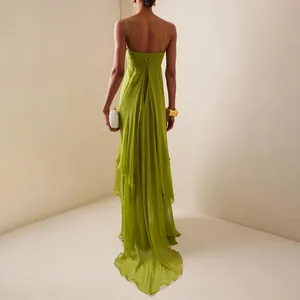Back view of a lime green flowing chiffon maxi dress with an irregular layered hemline