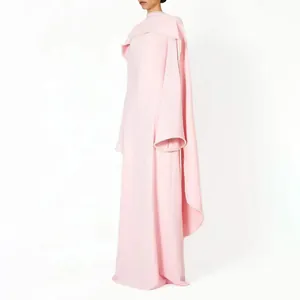 Side view of elegant pink long sleeve evening gown featuring a unique cape design detail