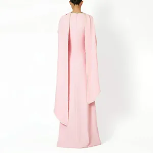 Detailed back view of a pink evening gown featuring an elegant cape with pearl trim
