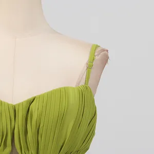 Close-up of pleated bust and adjustable strap on a lime green resort dress