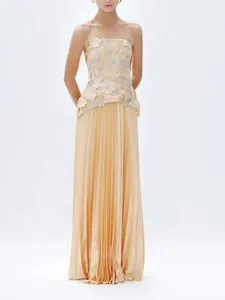 Elegant strapless top with 3D floral appliqués and matching pleated maxi skirt set.