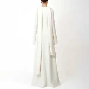 Detailed back view of an elegant white long-sleeved evening gown featuring pearl-edged cape panels