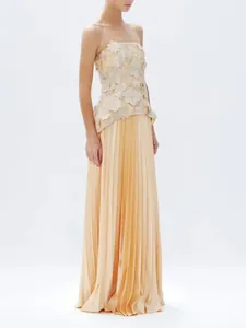 Elegant champagne strapless top with 3D floral appliqués and high-waist pleated maxi skirt