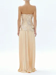 Elegant beige two-piece set featuring a strapless floral top and long pleated skirt