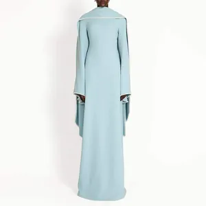 Full-length light blue evening gown with elegant cape sleeves and pearl trim detail