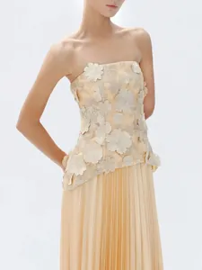 Elegant champagne two-piece set with 3D floral strapless top and pleated maxi skirt.