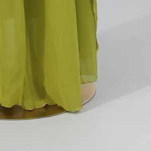 Detailed view of the flowing green chiffon hemline on a summer holiday dress