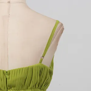 Close-up showing adjustable strap and pleated fabric texture on a lime green maxi dress