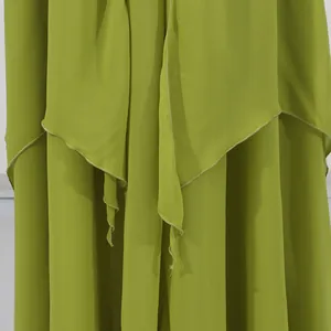 Close-up detail of olive green layered irregular hem on vacation style maxi dress