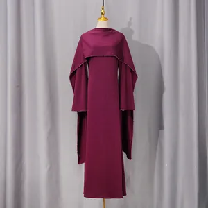 Detailed view of elegant purple evening dress with integrated cape and long sleeves