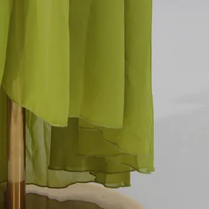 Close-up view of lime green ruffled hemline on a vacation style chiffon maxi dress
