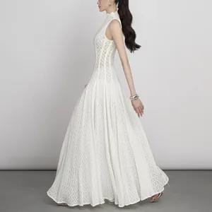 Elegant white lace sleeveless long dress with high neck and a slim fit flattering silhouette.