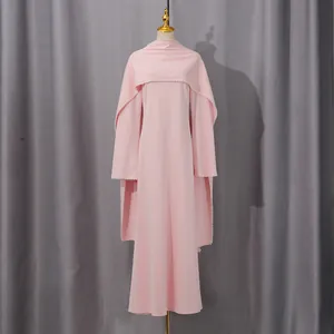 Elegant pink maxi dress with pearl-trimmed shawl detail on mannequin