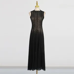 Detailed view of an elegant black retro lace long dress on a gold-topped mannequin