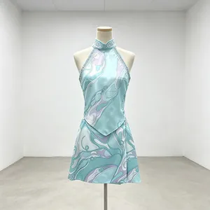 Elegant teal halter neck top and mini skirt set with abstract swirl prints on mannequin