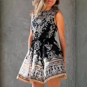 Close-up of French retro black sleeveless dress with intricate floral and pineapple prints