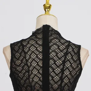 Close-up of the back of a vintage black lace dress featuring intricate patterns