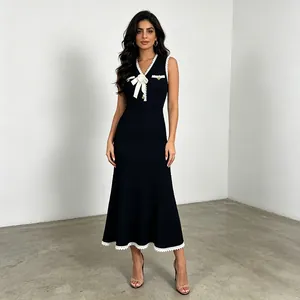 Detailed view of sleeveless knit fishtail dress with elegant white floral bow accent