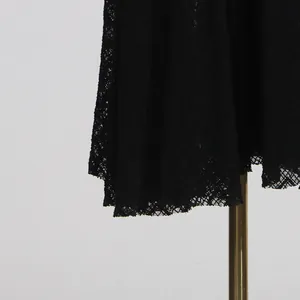 Close-up of the elegant black floral lace fabric detail on a vintage long dress hemline
