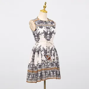 French vintage printed sleeveless dress with round neck and tie-waist shown on mannequin
