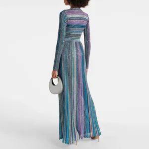 Back view of elegant long-sleeved knit maxi dress with colorful stripes and glitter.