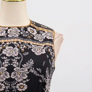 Detailed view of French vintage floral sleeveless dress with round neck on mannequin.