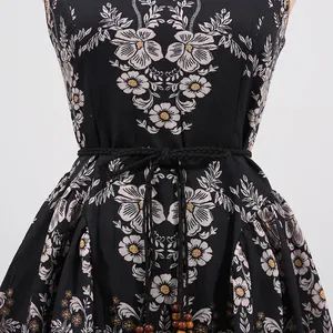 Close-up of French retro floral dress featuring a braided waist belt with beads