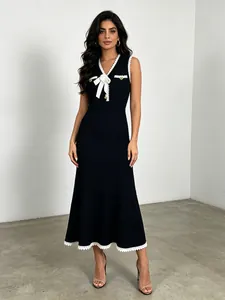 Elegant sleeveless black knit fishtail midi dress featuring 3D flower bow and lace trim details