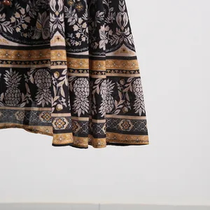 Close-up of bohemian pineapple and floral print detail on the hem of a vintage dress