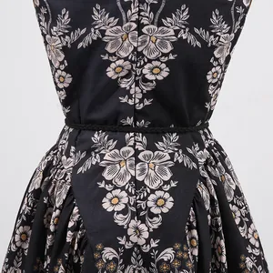 Close-up detail of a vintage floral print dress showing the waistline and fabric texture