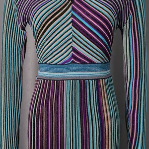 Close-up of a colorful striped knit dress showing elegant ribbed texture and sparkle threads
